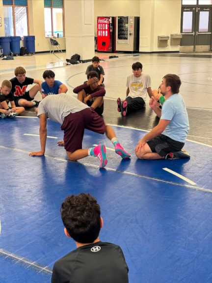 Coach Tristan Moran teaching leg riding at Southwest Wrestling Summer Camp 2025