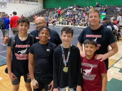 Two coaches's at the tournament with wrestling club wrestlers