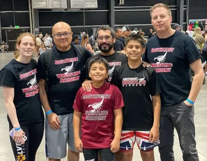 Coach Owen and coaches with wrestler at unstoppable wrestling tournament Gilbert, AZ