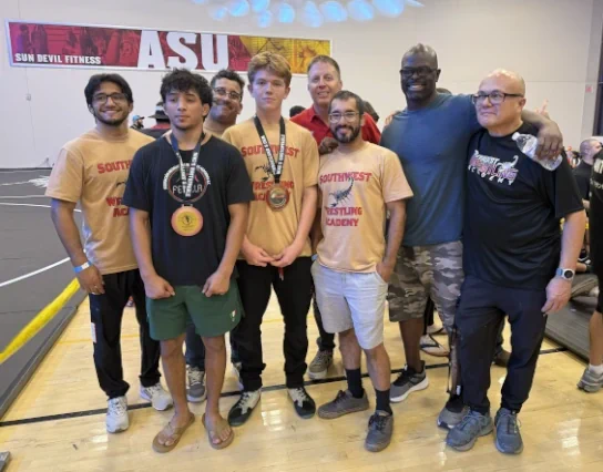 Coach Owen and coaches with wrestler at unstoppable wrestling tournament Tempe, AZ